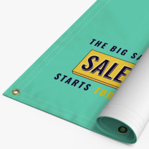 Rolled 18oz blockout banner with a sale message and brass grommets