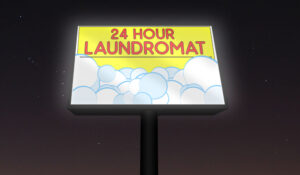 Backlit banner glowing at night in a laundromat pole sign light box